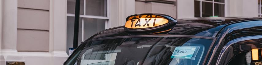 Taxi cab parked up on side of road